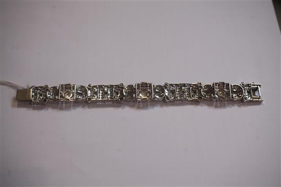 An attractive 1930s/1940s Art Deco white gold and diamond encrusted bracelet in Jays of London fitted box, 7in.